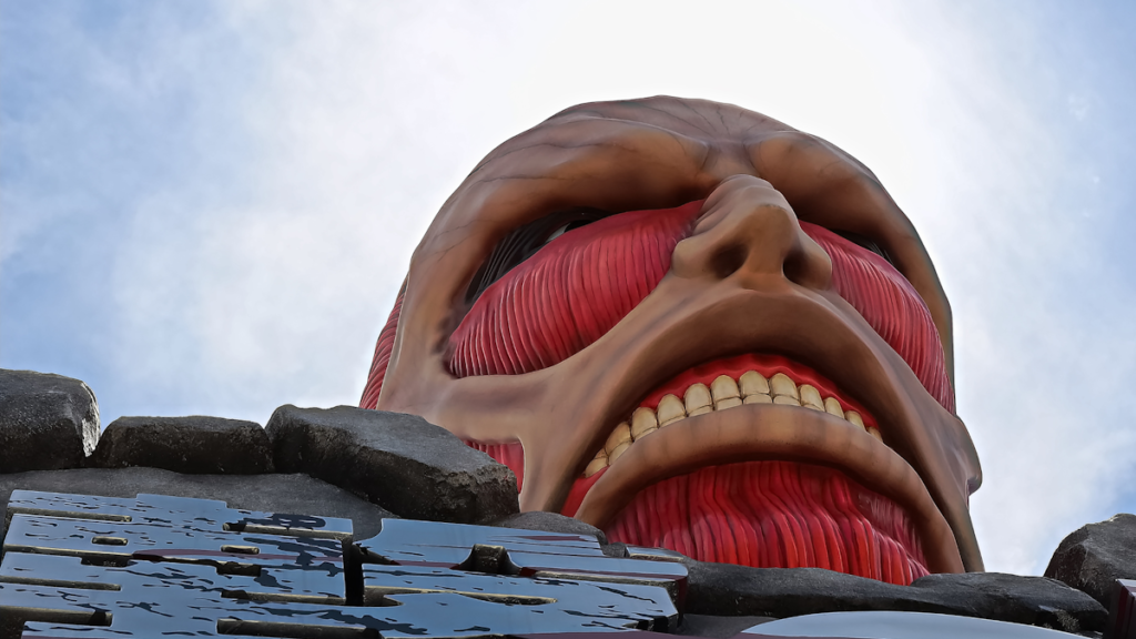 Anime Left and Right: Picture of one of the giants from Attack on Titan (skin stripped so musculature is showing) peering over a wall