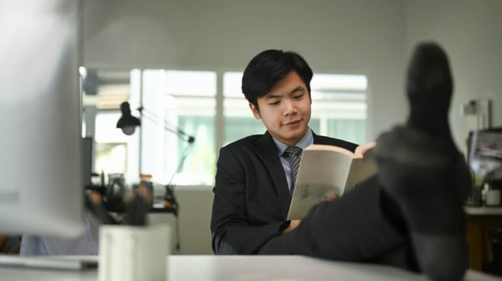 Company NEET - man with feet on desk