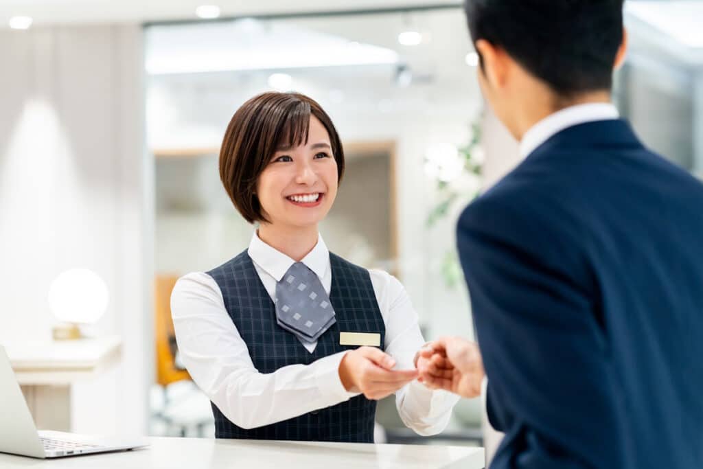 Hotel employee handing a guest his key