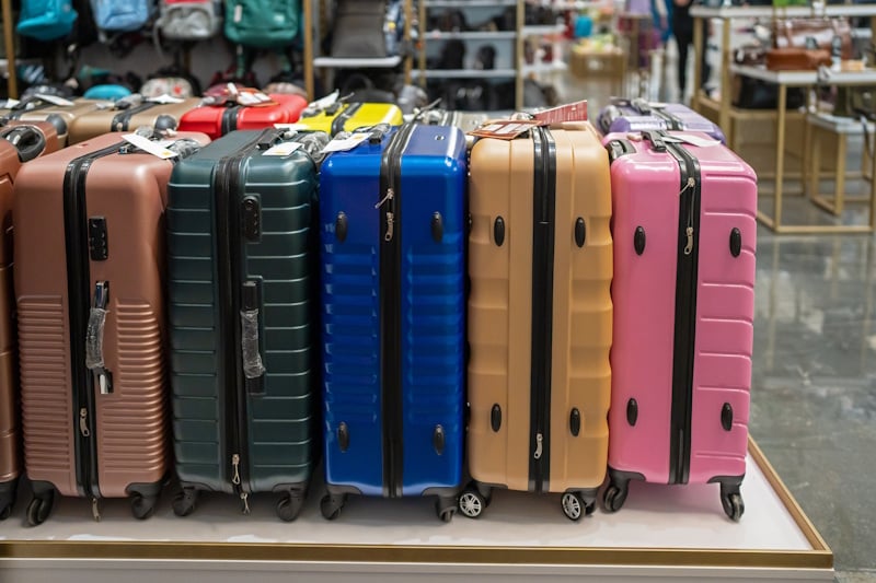 A row of suitcases in a store of different colors