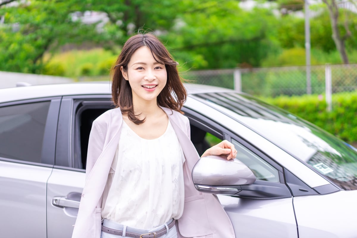 Woman standing next to her car