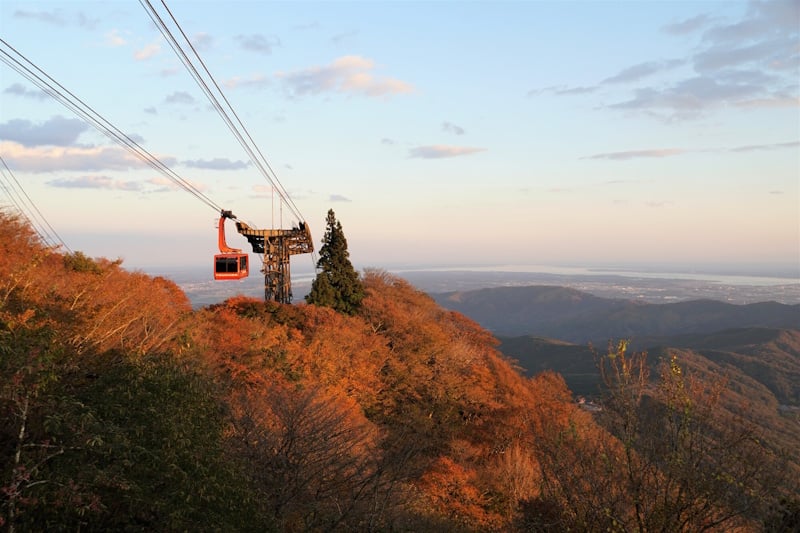 Mount Tsukuba Ropeway - red gondola against a background of autumn-colored mountains