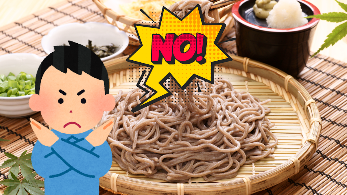 Picture of soba on a bamboo plate with an Irasutoya man in front of it crossing his arms and saying "no"