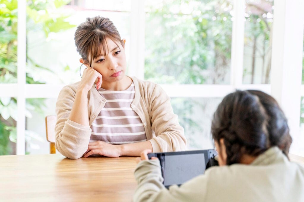 Mother looking at her daughter with weary eyes