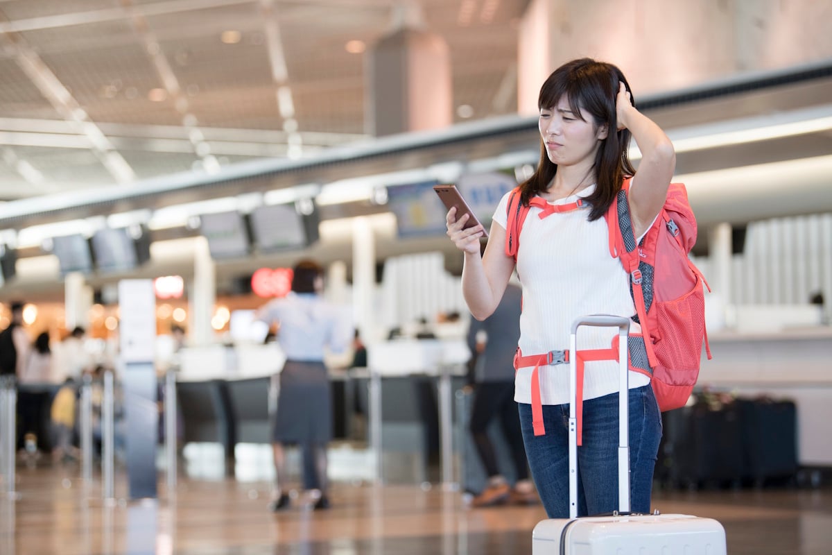 Woman looking confused and in trouble at an airport