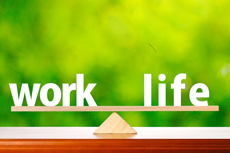 A picture of the words "work" and "life" balanced on a fulcrum