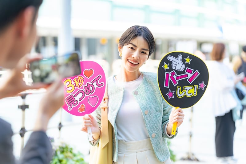 Woman holding oshi banners