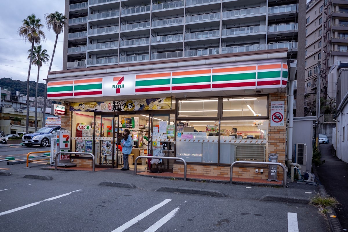 Woman standing outside of a 7-Eleven in Atami, Shizuoka Prefecture
