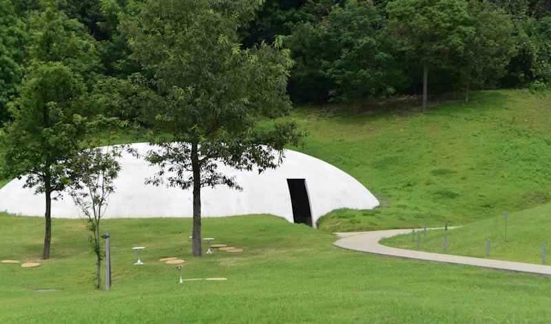 The Teshima Art Museum, a white building built into the surrounding natural landscape